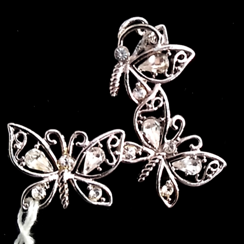 Butterfly Brooch silver background  with diamond like stones